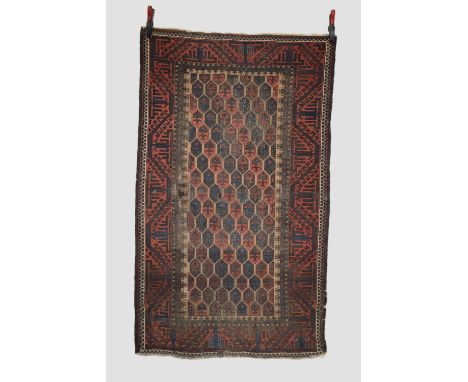 Two Baluchi rugs, Khorasan, north east Persia, early 20th century, the first: 5ft. 10in. X 3ft. 6in. 1.78m. X 1.07m. Overall 