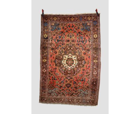 Saruk rug, north west Persia, circa 1930s-40s, 6ft. 8in. X 4ft. 8in. 2.03m. X 1.42m. Slight loss to ends. Light red field wit