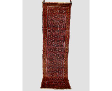 Hamadan runner, north west Persia, circa 1930s, 9ft. 10in. X 2ft. 11in. 3m. X 0.89m. Few small paint marks.  Light red field 