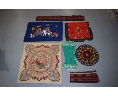 Group of  seven textiles comprising Uzbek circular mat, a green silk panel, and a red felted square all embroidered in a brig