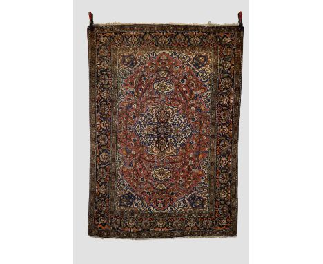 Esfahan rug, central Persia, circa 1930s-40s, 6ft. 11in. X 4ft. 10in. 2.11m. X 1.47m.  Light red cartouche shaped field with 