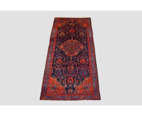 Hamadan kelleh, north west Persia, circa1940s-50s, 11ft. 4in. X 5ft. 2in. 3.45m. X 1.58m. Dark blue field with pink centre me