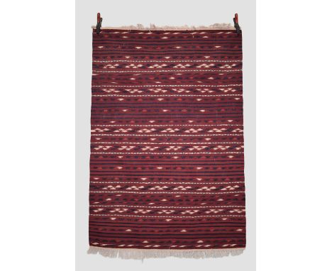 Two Afghan weavings, late 20th century, the first a Turkmen kelim, 5ft. 9in. X 3ft. 11in. 1.75m. X 1.20m. Narrow bands with i