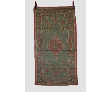 Two rugs: The first an Indian rug, circa 1940s-50s, 5ft. 11in. x 3ft. 2in. 1.80m. x 0.97m. Some wear in places with slight lo