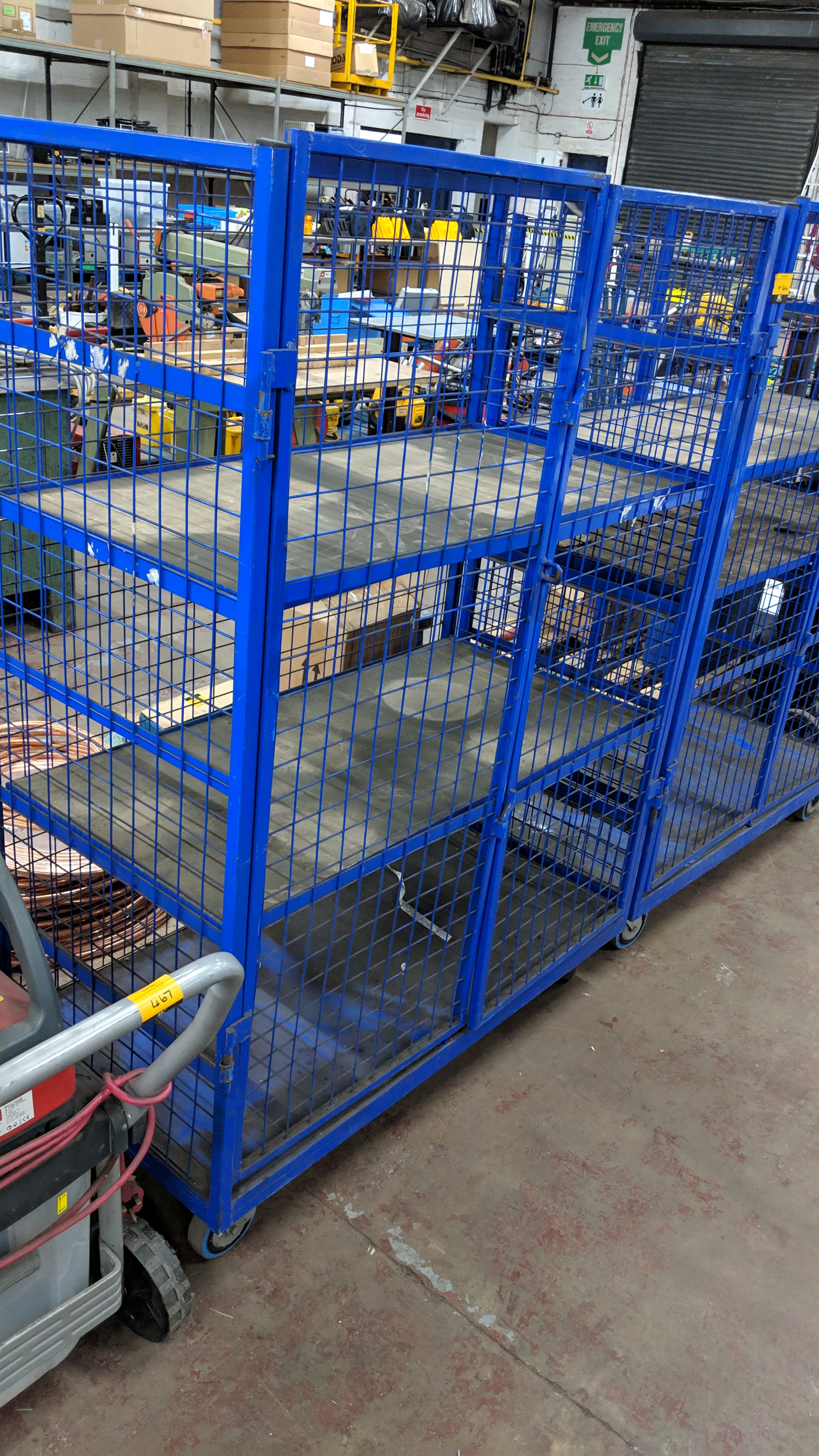 2 off blue lockable cage trolleys, each with 2 height adjustable ...