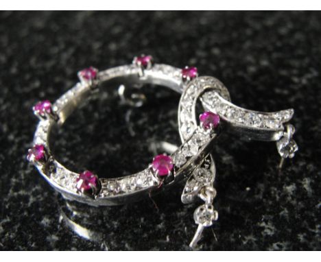 A diamond and ruby brooch