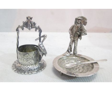 A silver well with stork; together with one other with chimney sweep