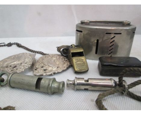 A quantity of whistles; together with a horn snuff box, nurse's buckle, money box etc