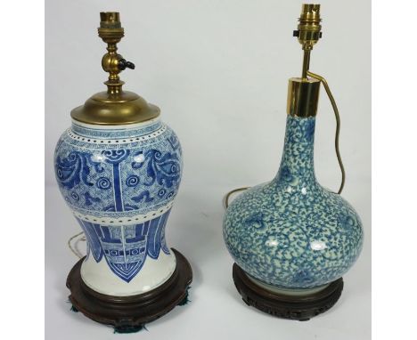 A Chinese blue and white baluster vase, Qing dynasty, decorated with stylised eyes and other motifs, now fitted as a table la