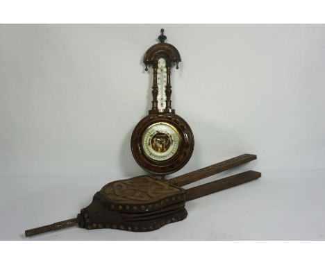 A late Victorian aneroid barometer and thermometer, in an carved case; together with a pair of oak cased bellows (2)