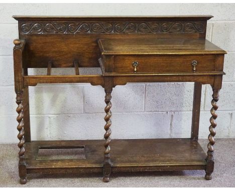 An early 20th century oak hall stand, with twist column supports, a single drawer and offset stick stand, 99cm high, 124cm wi