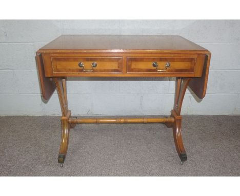 A Regency style yew veneered sofa table, 20th century, 76cm high, 92cm wide (closed); together with two modern TV cabinet (3)