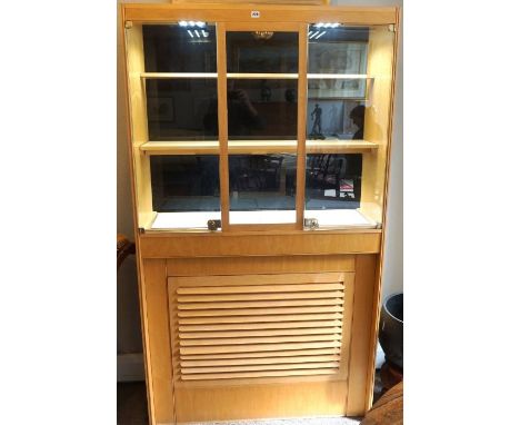 A modern cherry veneered Jewellers shop display cabinet, with a glazed top, fitted with shelves and lighting, over a louvre b