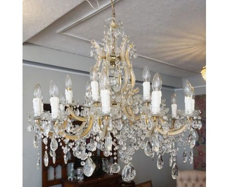 A large cut glass crystal two tiered eighteen light chandelier, 20th century, the central stem with six section basket issuin