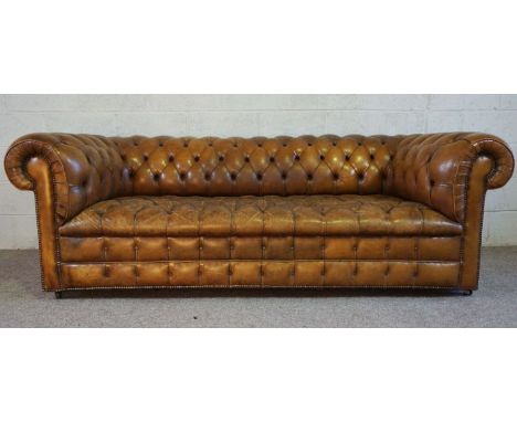 A vintage leather button backed Chesterfield Sofa, with nicely worn in brown leather seat, 77cm high, 220cm wide