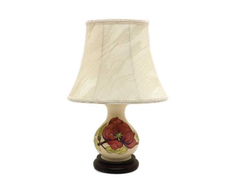 A small Moorcroft pottery 'Anemone' pattern table lamp,late 20th century, of baluster form, with an oval silk shade and a ste