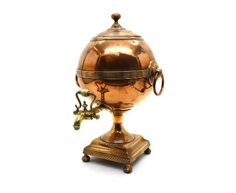 A copper and brass samovar, early 19th century, the globular body with pull off lid, ring handles and brass tap, above a rect