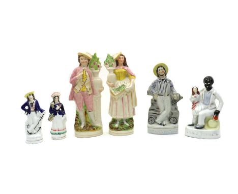 A pair of Staffordshire flatback figures,19th century, of a lady and gallant hilding vases of flowers,31cm hightogether with 