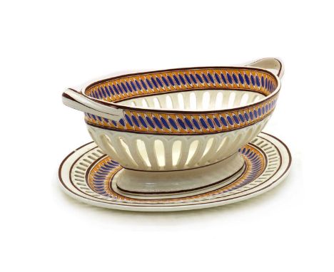 A Spode creamware chestnut basket and stand,c.1820, of navette pedestal form with pierced ribbon border and painted blue and 