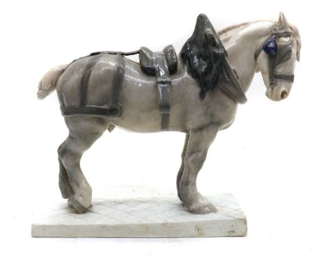 A Royal Copenhagen porcelain figure, of a harnessed French Percheron heavy horse, standing on a plinth base by C.J. Buenesen 