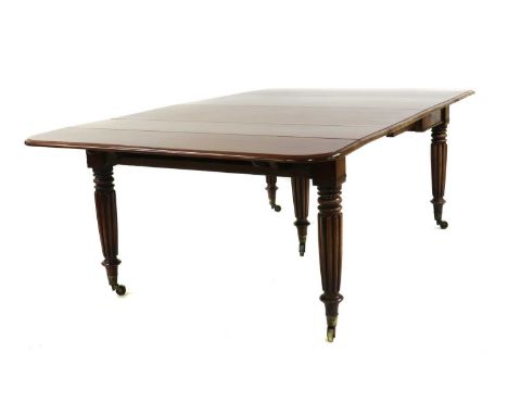 A mahogany drop flap extending dining table in the manner of Gillowc.1840, raised on reeded legs terminating in Cope and Coll