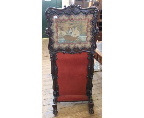 An unusual carved mahogany Victorian screen with tapestry top and claw feet