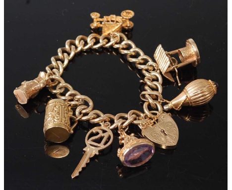 A 9ct yellow gold rounded curblink charm bracelet, with padlock and safety chain, charms attached as follows; a 9ct engraved 