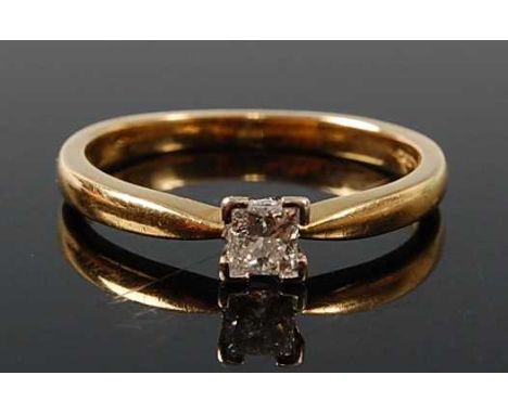 An 18ct yellow and white gold diamond single stone ring, comprising a Princess cut diamond in a four-claw setting, diamond di