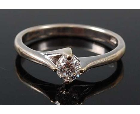 A 9ct white gold diamond single stone ring, featuring a round brilliant cut diamond in a a four-claw compass setting, diamond