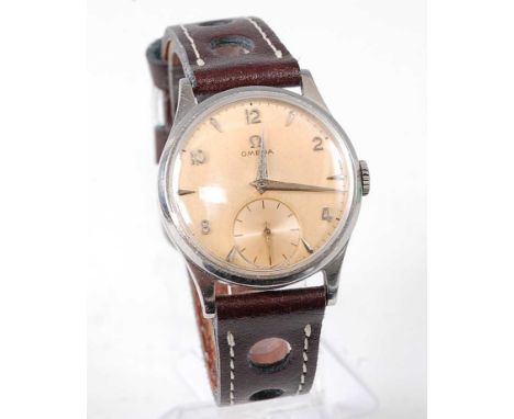 A gent's Omega steel cased wristwatch, having a champagne dial with Arabic even numerals, subsidiary seconds dial, calibre 26