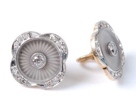 A pair of yellow and white metal diamond set buttons, each with a centre round brilliant cut diamond bezel set in the centre,