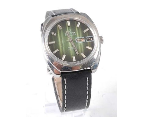 A gent's Enicar Ultrasonic steel cased wrist watch having a signed green day/date dial, baton markers, automatic 25 jewel Inb