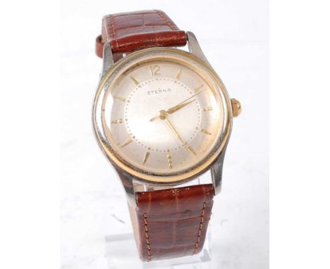 A gent's Eterna steel cased wrist watch having gold plated bezel, signed silver dial with baton markers, manual wind movement