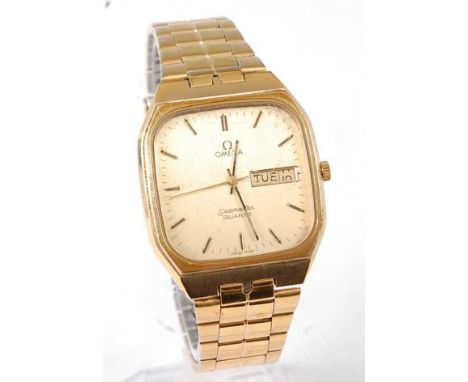 A gent's gold plated Omega Seamaster quartz bracelet watch, having signed champagne day/date dial, steel back cover, with Ome