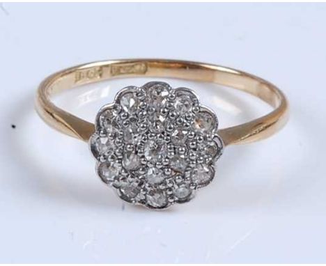 A yellow and white metal diamond circular cluster ring, featuring nineteen Old European cut diamonds in grain settings, diamo