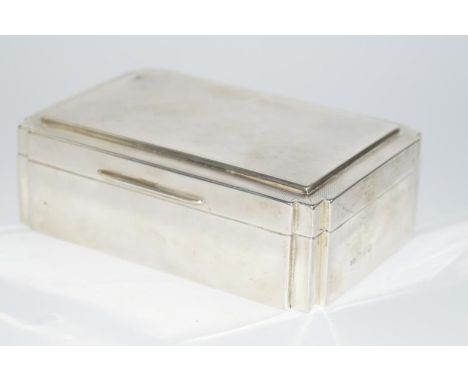 A George V silver cigarette box, of Art Deco rectangular design, with engine turned decoration, Chester 1930, 14.3cm.