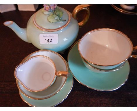 A Crown Devonshire early morning tea set, comprising of a teapot, milk jug, sugar bowl and stand, and two cups and saucers, i