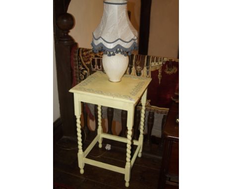 A 1930's bobbin twist table, later shabby chic decorated in yellow with floral transfers to the border, and a modern table la