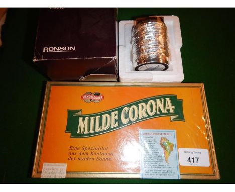 Table cigarette lighter and a box of Milde Corcorona cigars.