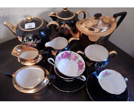 A Sadler teapot and hot water jug, with matching sugar bowl and sucrier and other similar teaware.