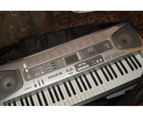 A Casio electric keyboard, with carrying case, a small quantity of other travel cases, etc, (a quantity).