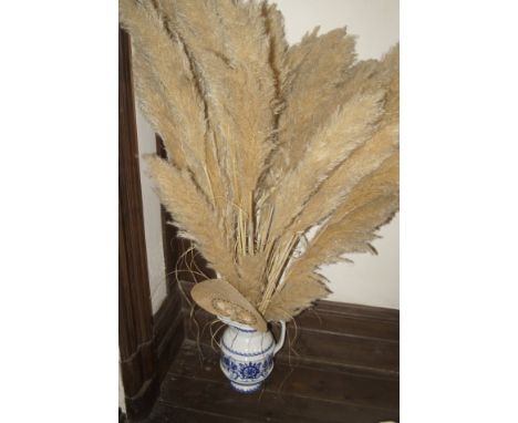 A modern artificial floral arrangement, a modern decorative table lamp with shade and a 19thC blue and white jug with dried f