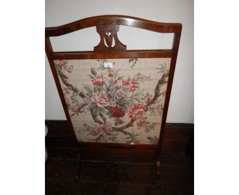 A 1920's mahogany firescreen, with floral printed glazed panel.