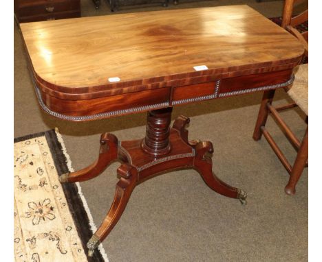 A regency mahogany fold over card table