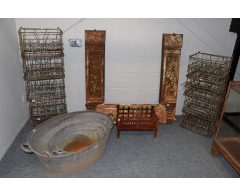 A graduated set of four twin handled galvanized pails, a group of wrought metal milk bottle crates, and a cast iron fire surr