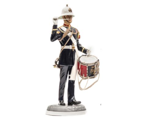 A painted “Michael Sutty Porcelain Manufactory” figure of a “Bugler, Royal Marines, 1989”, in full dress with sidedrum and dr