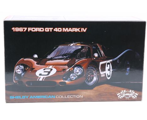 A GMP 1:12 scale 1967 Ford GT 40 Mark 1V. A finely detailed model finished in metallic bronze with white racing stripes, RN3.