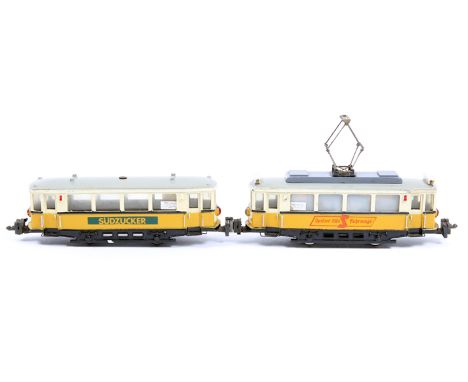 An interesting German made HAMO HO 2-rail 2-car tram set. Comprising a 4 wheel power car with a single roof mounted pantograp
