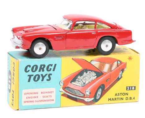 Corgi Toys Aston Martin D.B.4 (218). An example in red with no bonnet vent, yellow interior and smooth wheels. Boxed, minor c