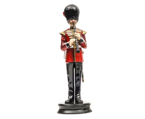 A similar figure of a bandsman “Coldstream Guards” in full dress with clarinet and sidearm, “Model No 53”, height overall 12”